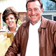 A 1993 photo of alleged "sex-for-security" scam artist Helen Crandall. Police suspect the groceries she is holding were paid for by her victim, husband Russell Crandall (right).